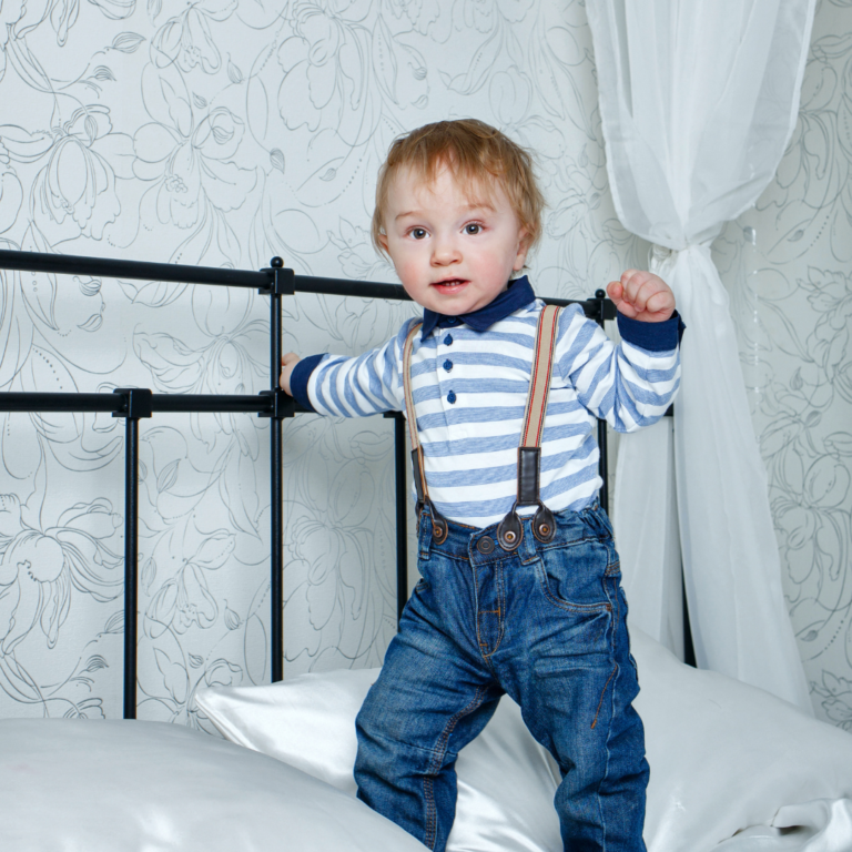 boy standing on bed